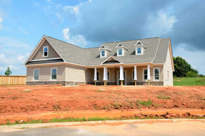 Storm-damaged roof with missing shingles being assessed by certified roof replacement contractors in Apex, North Carolina