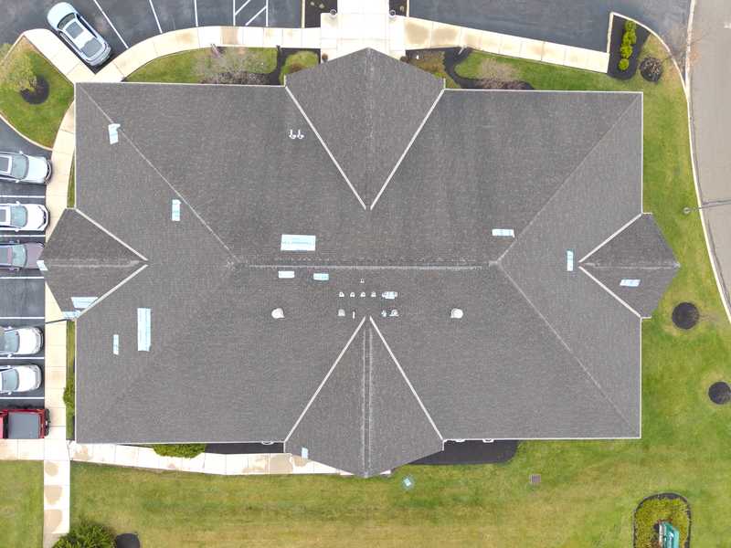 Roof Revivers tarp several spots on a Dublin, Ohio business after severe weather causes roof damage.