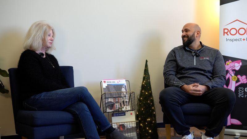 Roof Revivers president Reed Dietz sits for a customer testimonial with Susanne of Village at Deer Creek Condominiums.