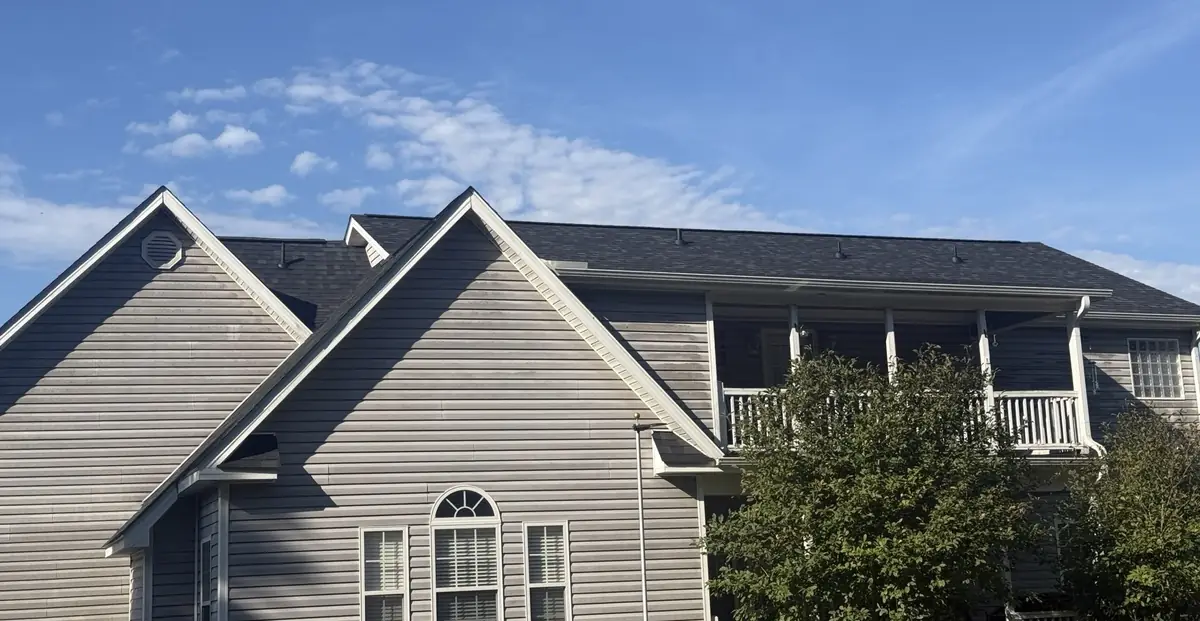 New dark Owens Corning shingle roof with ridge vent across the main house in Benson, North Carolina, after replacement