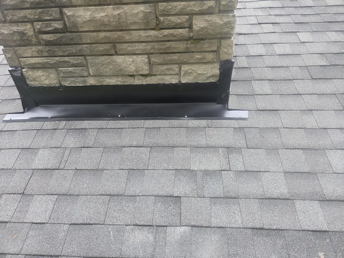New front apron flashing at the chimney base on a Blacklick, Ohio roof, after repair