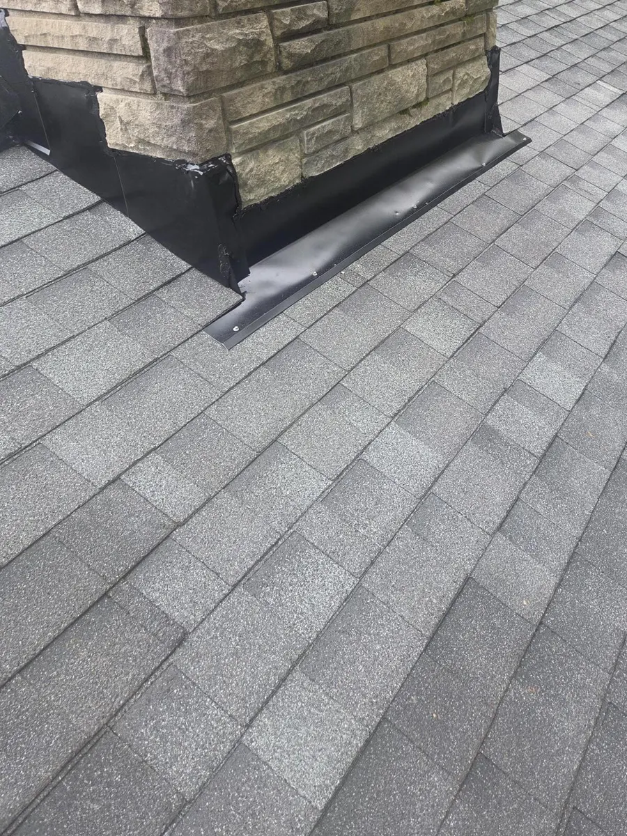 New chimney side flashing and shingles in Blacklick, Ohio, after repair