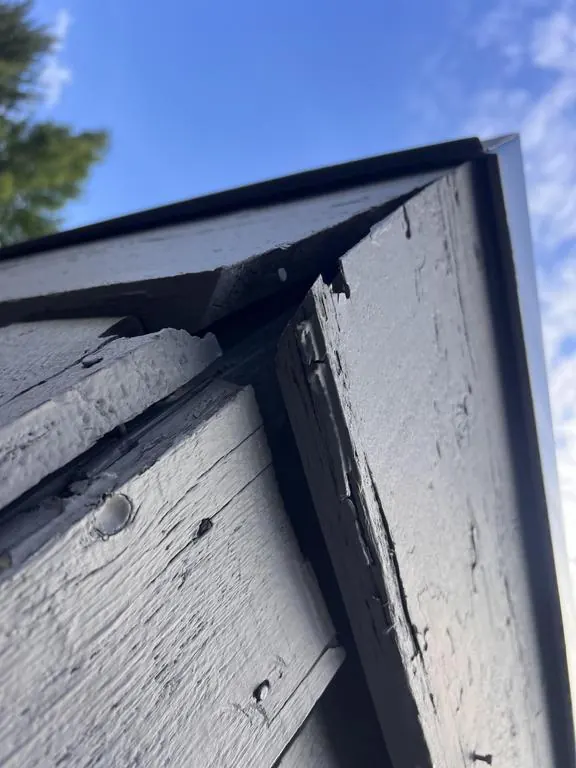Split and rotted corner trim at the top of a Columbus, Ohio chimney chase