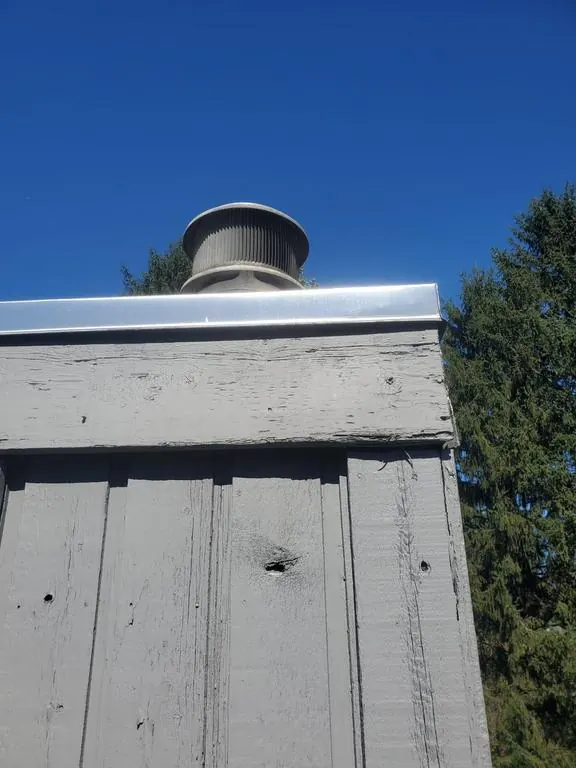 New trim boards and sealed seams at the top of a Columbus, Ohio chimney chase