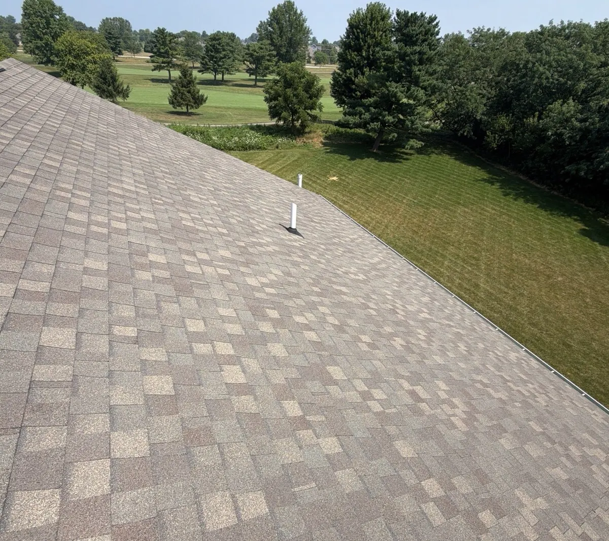 Weathered original asphalt shingles across the back slope of a Delaware, Ohio home, before roof replacement