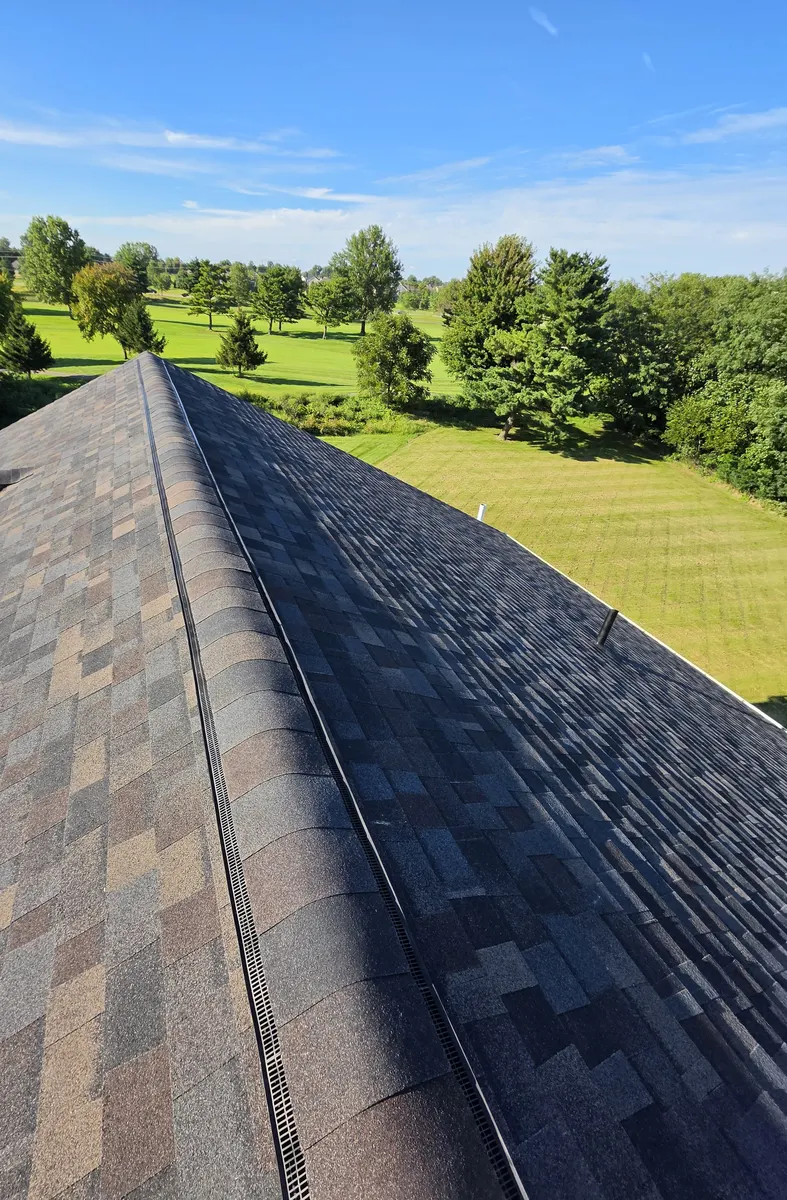 New ridge vent and Black Sable ridge cap over Owens Corning Duration FLEX shingles in Delaware, Ohio, after roof replacement