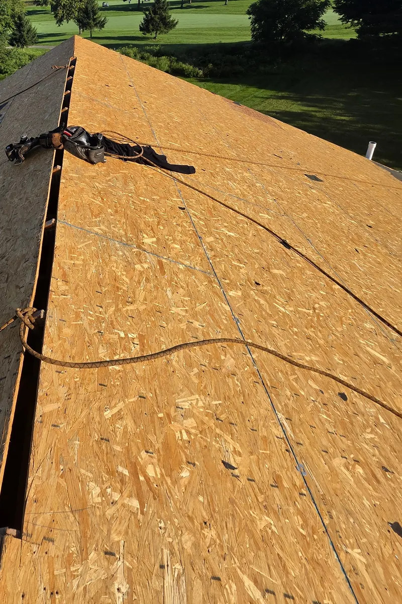 Ridge anchor and safety line on the bare roof deck during a roof replacement in Delaware, Ohio