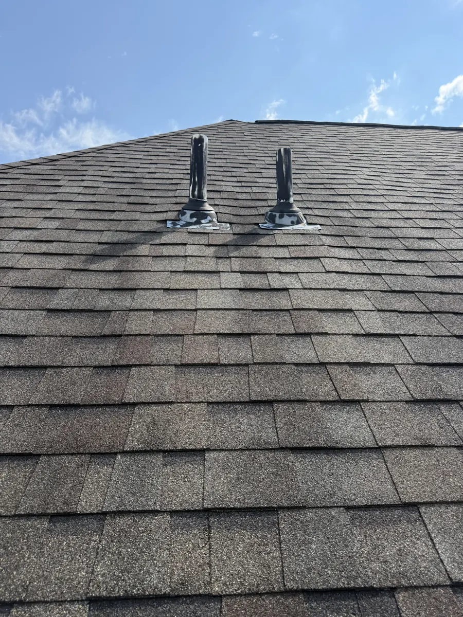 Two plumbing vent pipes on a Dublin, Ohio roof, before pipe boot repair