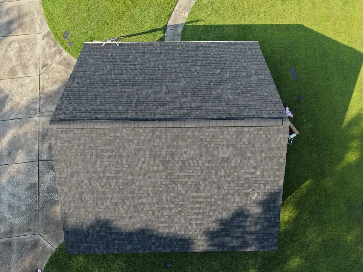 Weathered gray shingles on a detached garage roof in Dunn, North Carolina, before replacement