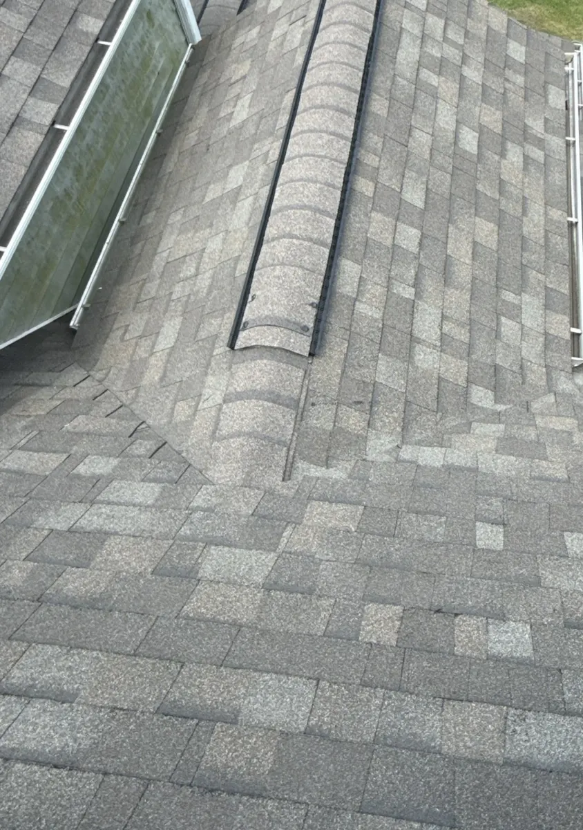 New Owens Corning shingles and ridge caps around the dormer next to the skylight in Dunn, North Carolina, after replacement