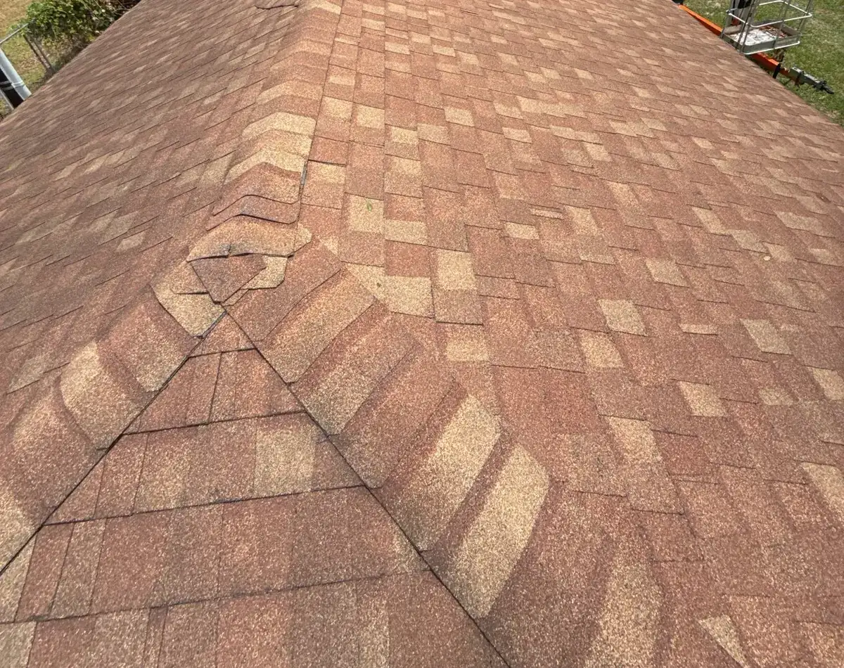 Old shingles on a hip roof in Goldsboro, North Carolina, before replacement