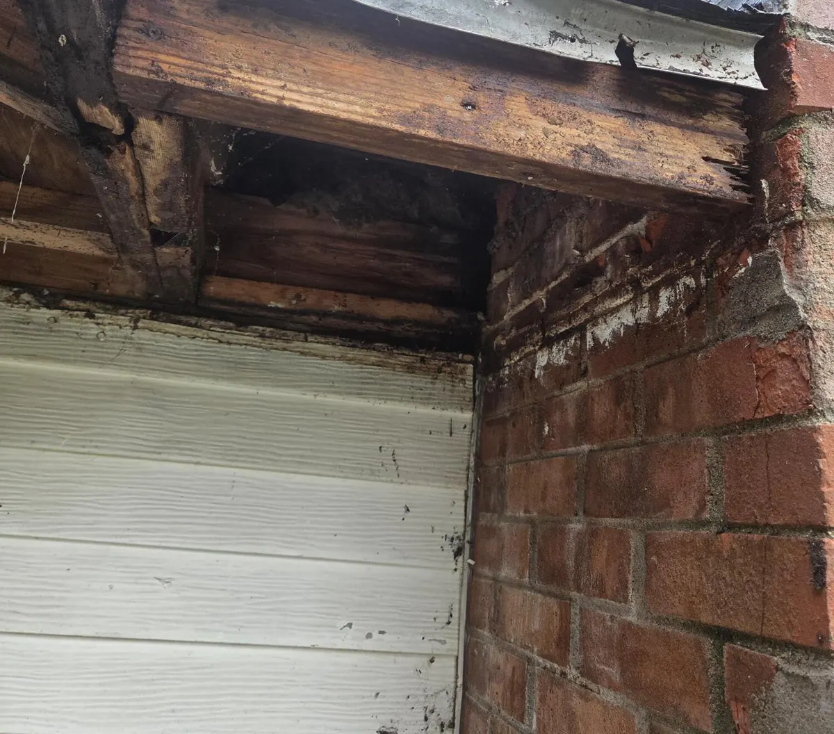 Rotted fascia board and soffit framing exposed at the chimney corner during the Groveport, Ohio repair