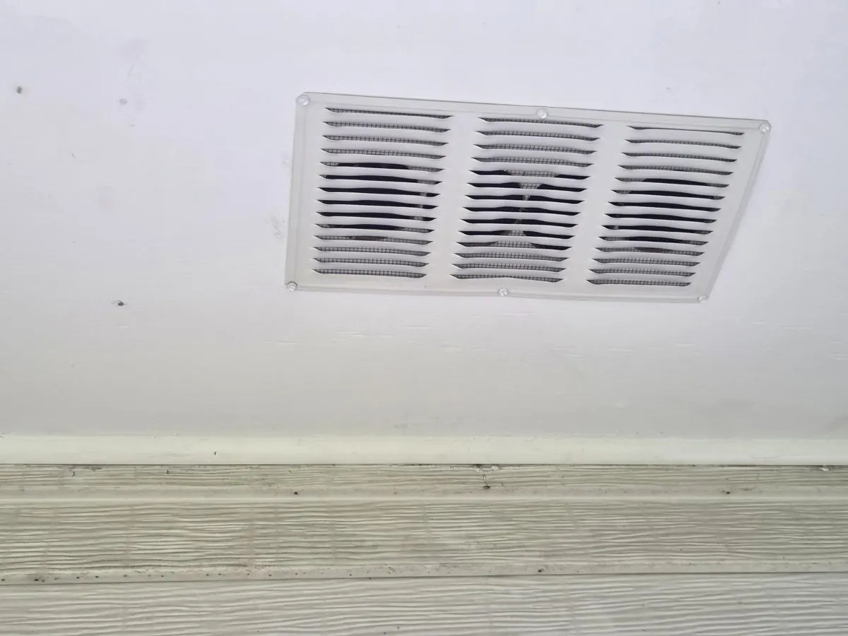 New aluminum soffit vent and trim in the new soffit along the rear eave in Groveport, Ohio, after repair