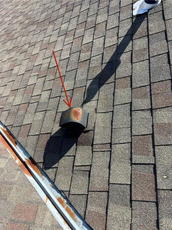 Rusted open metal valley and nearby vent on a Hilliard, Ohio roof at inspection