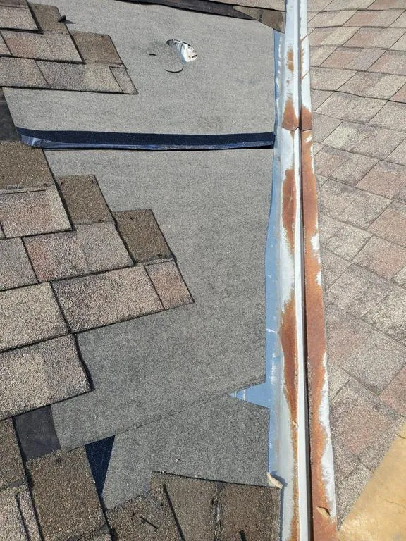 New underlayment beside the open metal valley during a Hilliard, Ohio repair