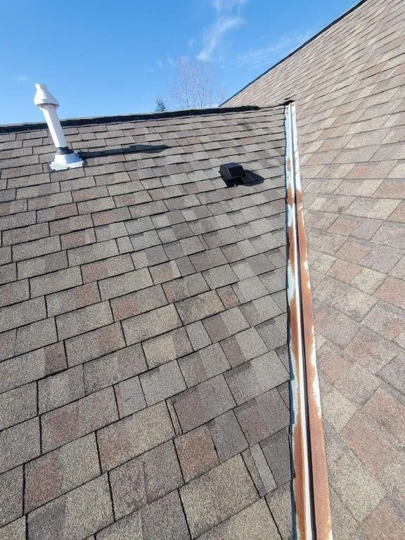 Re-shingled slope along the open metal valley in Hilliard, Ohio, after repair