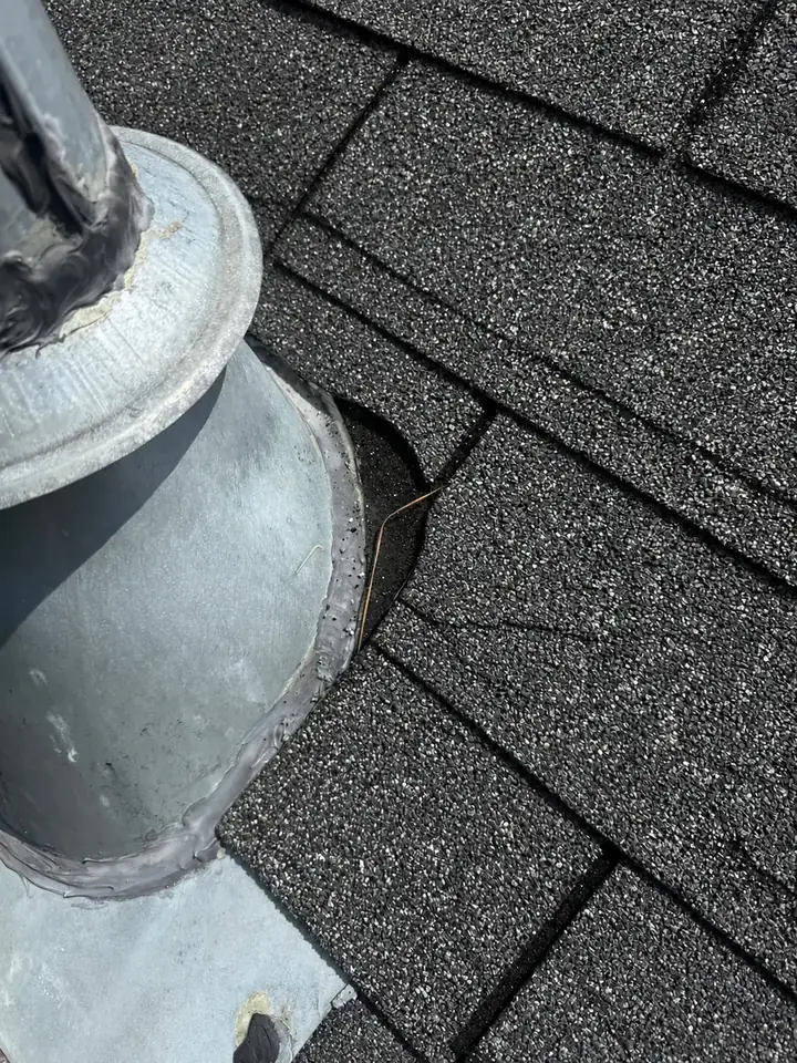 Gas vent pipe collar and flashing on a Holly Springs, North Carolina roof at inspection, before the leak repair