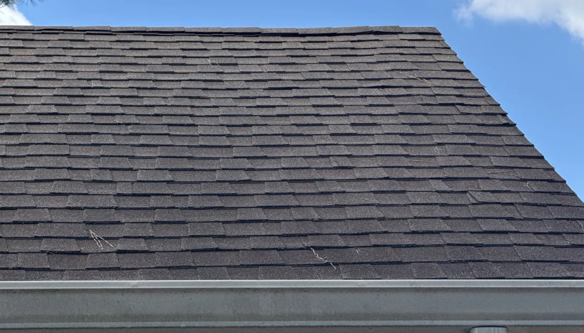 Weathered brown architectural shingles on a roof plane in Linden, North Carolina, before replacement