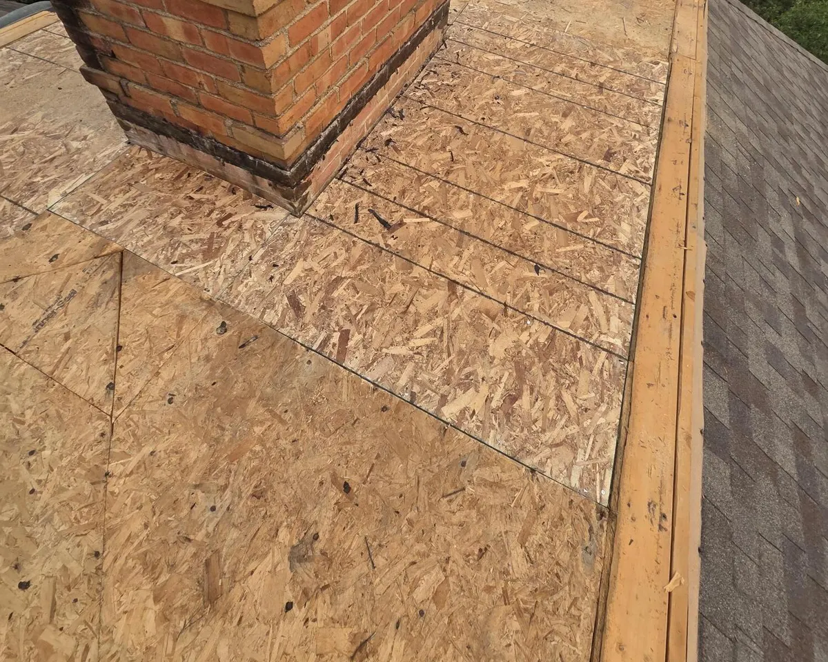 New OSB decking installed around the chimney on the flat roof during the New Albany, Ohio repair
