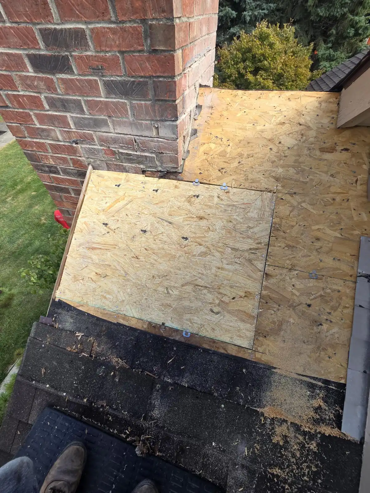 New roof decking installed beside the chimney during a Powell, Ohio chimney flashing repair
