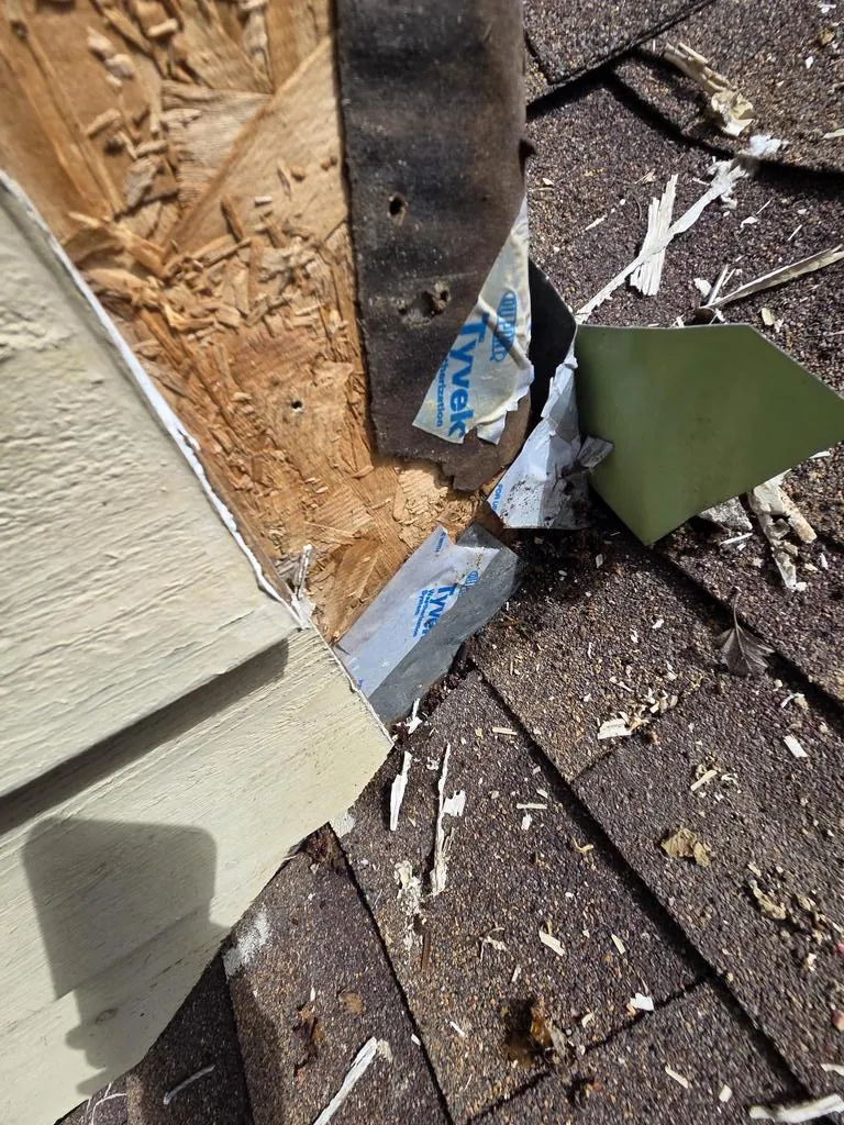 Rotted trim and old flashing where a dead valley meets the wall on a Powell, Ohio roof