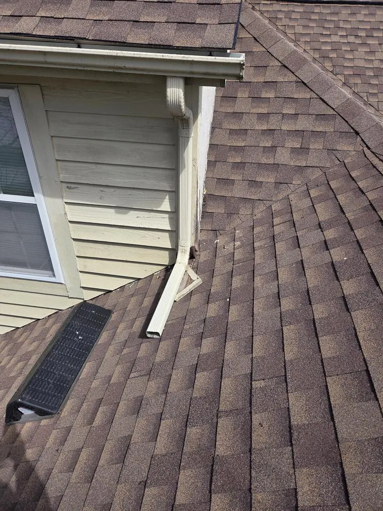 New trim and shingles where the roof meets the wall in Powell, Ohio, after repair
