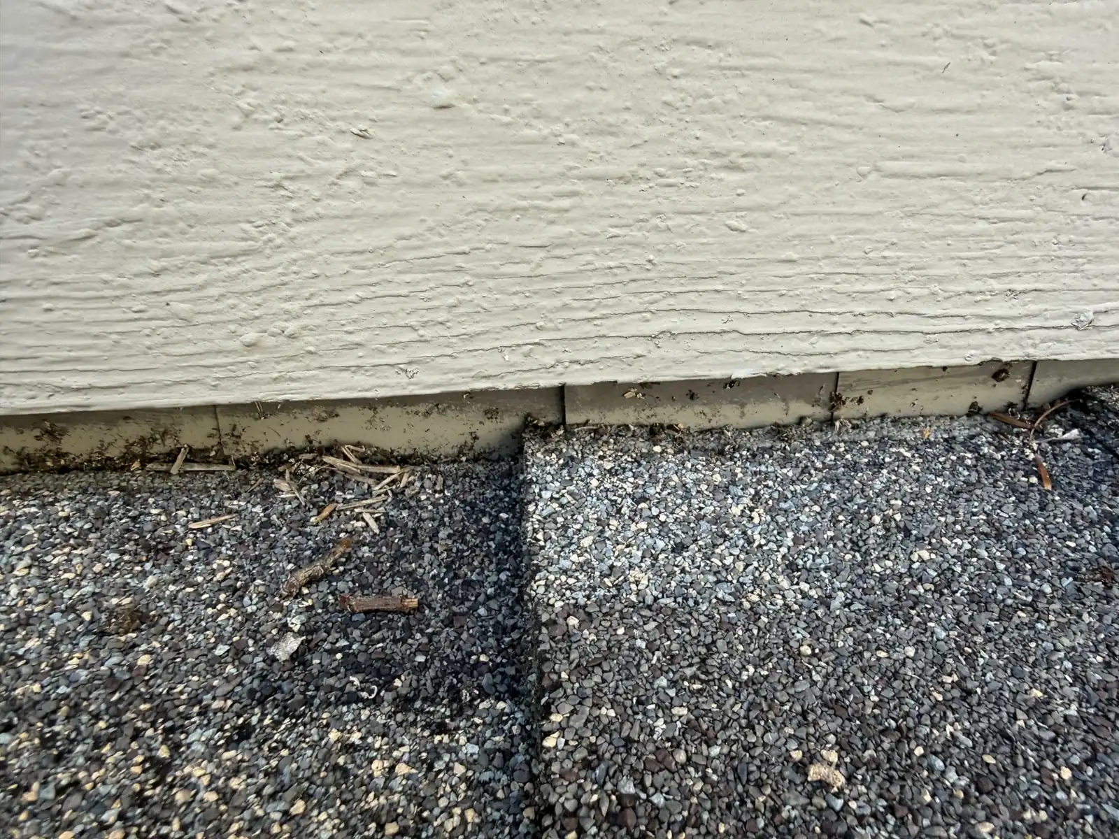Gap between siding and shingles at a roof-to-wall junction in Powell, Ohio, before step flashing repair