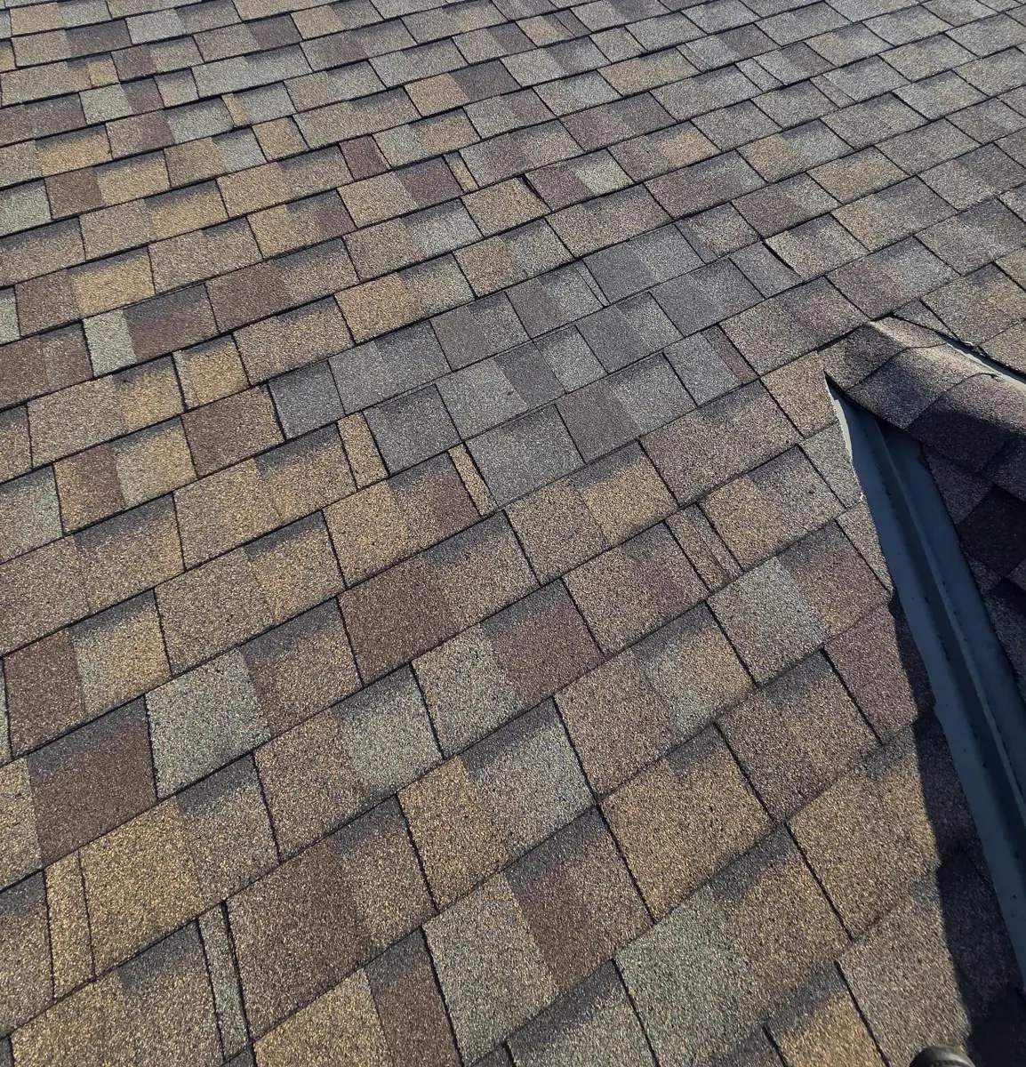 Repaired roof slope next to a dormer in Reynoldsburg, Ohio, after repair
