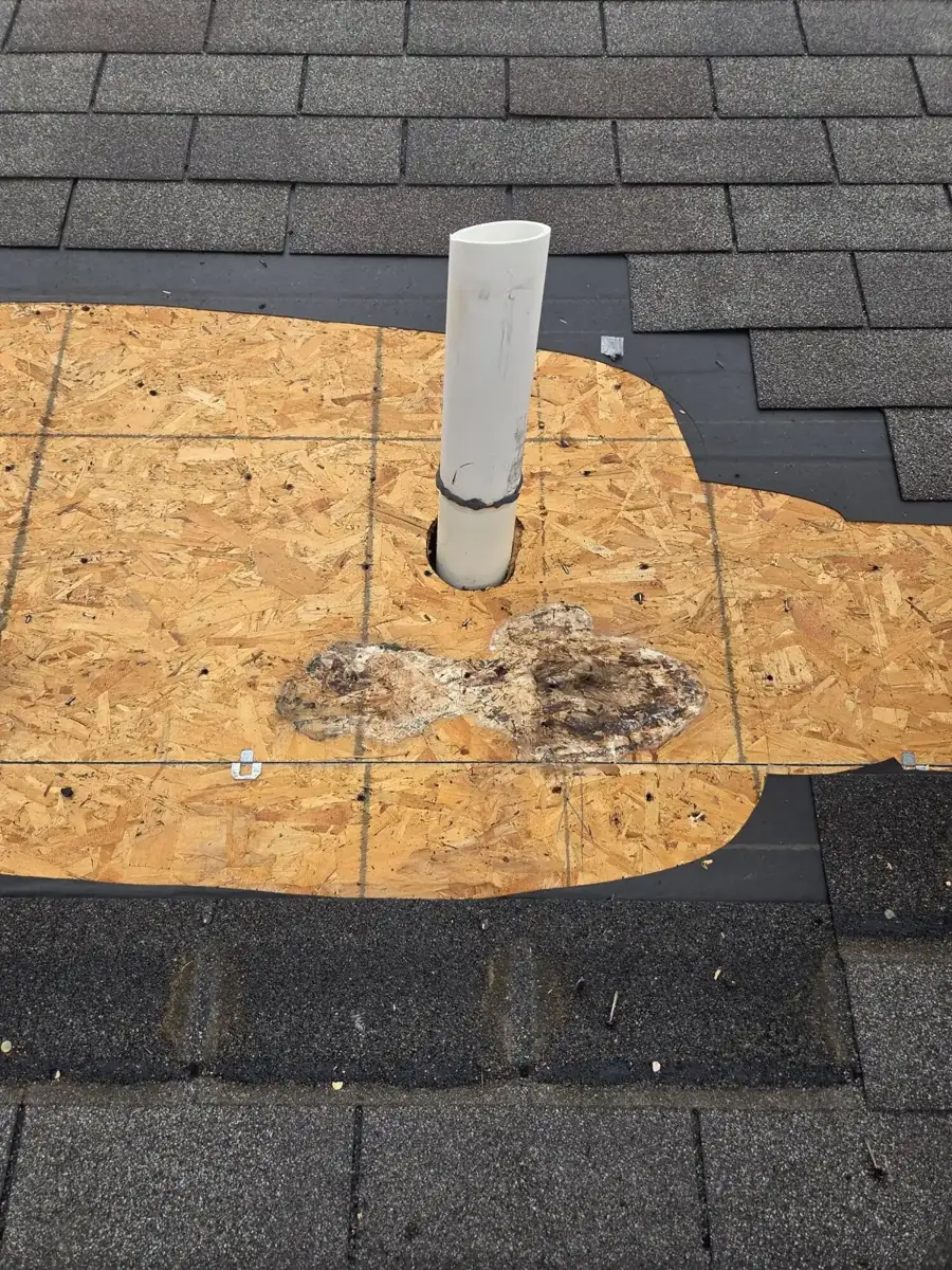 Patched roof decking around a vent pipe during a Westerville, Ohio pipe boot replacement