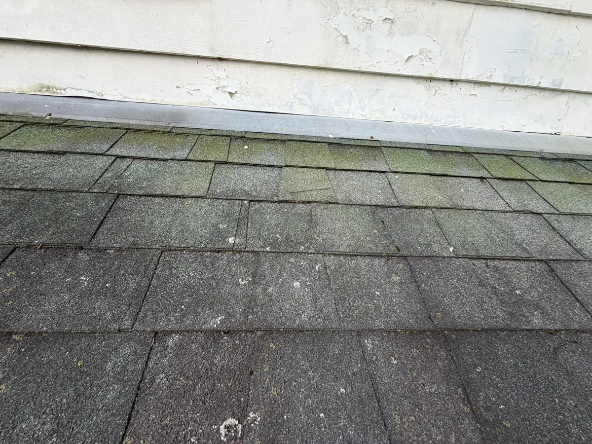 Worn shingles where a roof meets the wall on a Westerville, Ohio home