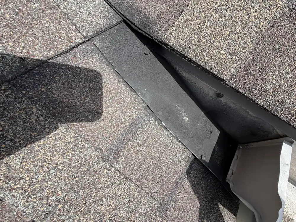 Roof-to-wall junction above the gutter on a Westerville, Ohio home, before flashing repair