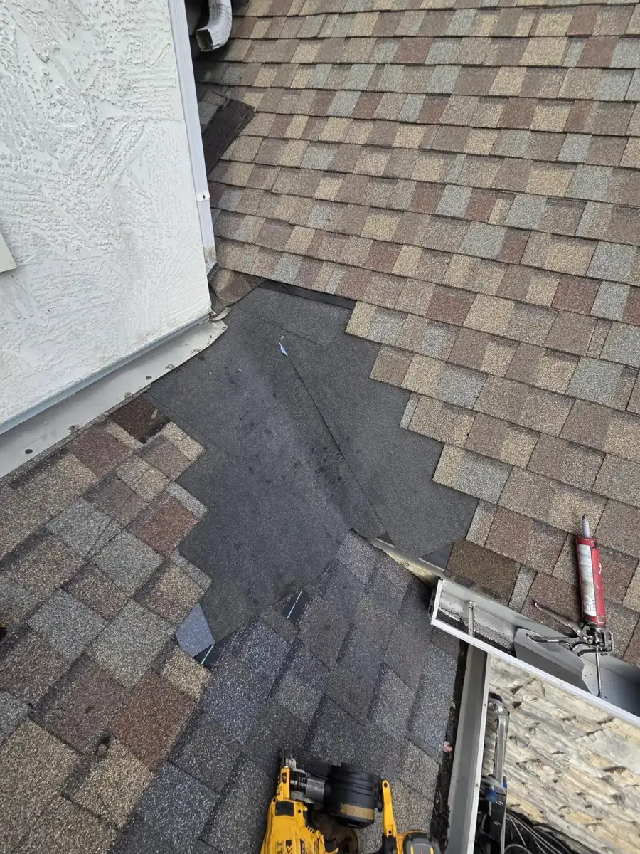 Underlayment and new shingles going in at the wall and gutter junction during a Westerville, Ohio repair