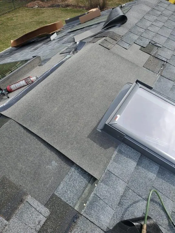 Shingles opened and new flashing around a skylight during a Westerville, Ohio replacement