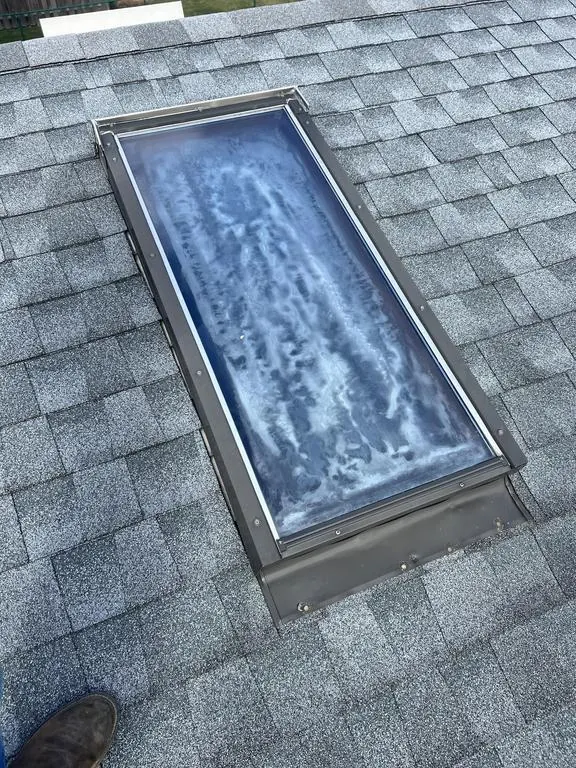 Fogged, failing skylight glass on a Westerville, Ohio roof, before replacement