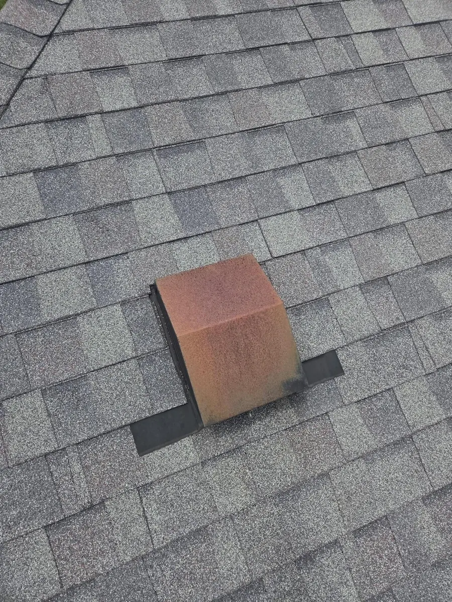 Old rusted bath vent cover on a Worthington, Ohio roof, before repair