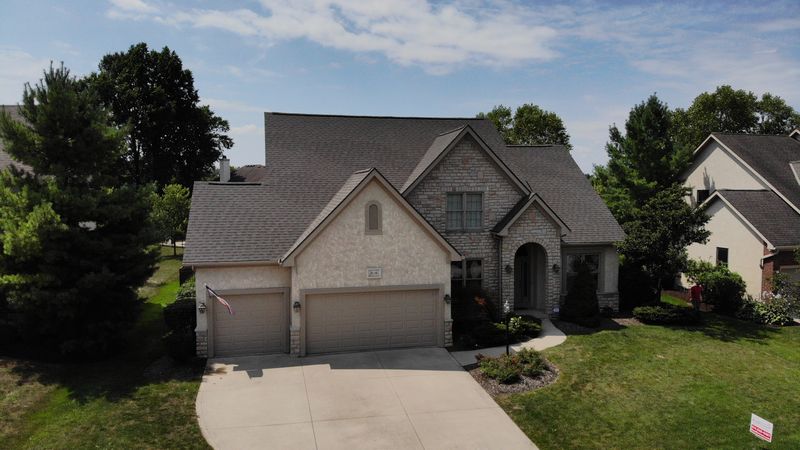 A home with an expert installed roof by Roof Revivers, a roofing company in Lewis Center Ohio.